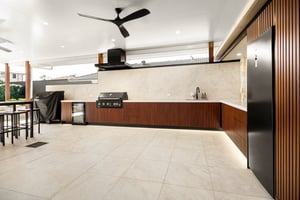 Custom outdoor kitchen with Spotted Gum AliBattens cabinetry and 60mm Corian Whisper benchtops